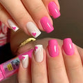 Close-up of hands with pink and white nail design, holding a pink nail polish bottle, Obroi