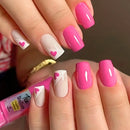 Close-up of hands with pink and white nail design, holding a pink nail polish bottle, Obroi