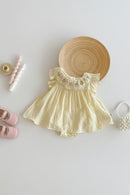 Yellow baby romper with floral embroidery on a light background, Obroi