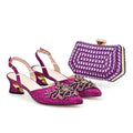 Pair of pink high-heeled shoes with gold embellishments and a matching purple handbag on a white background, Obroi