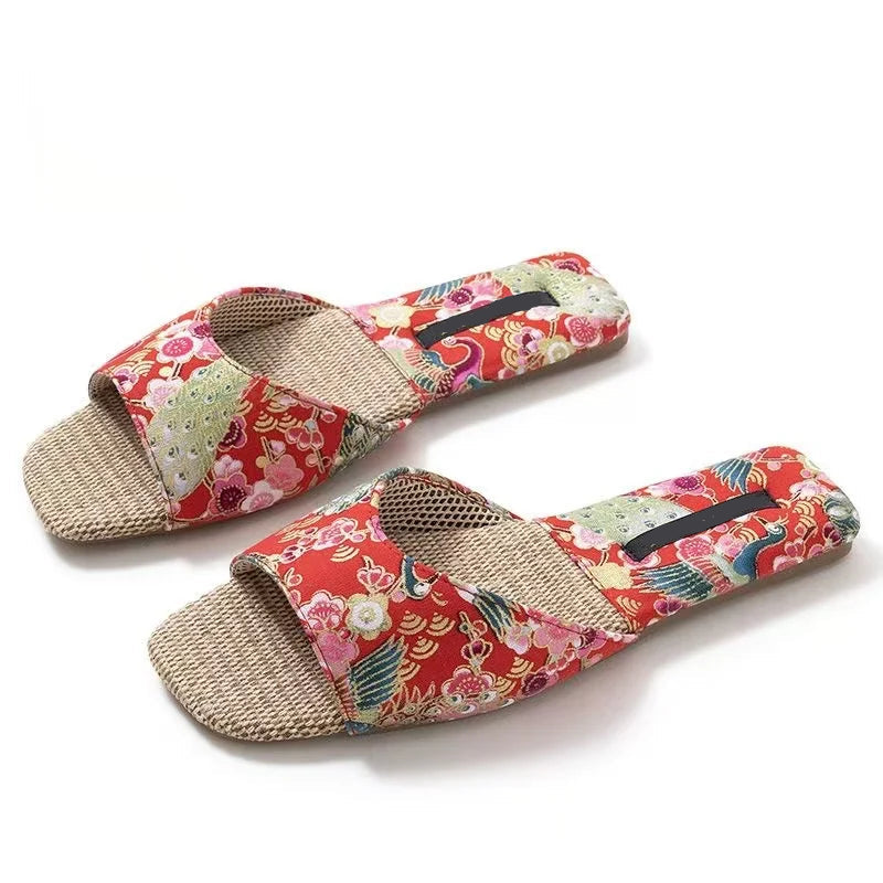 Pair of floral-patterned slippers with jute sole on a white background, Obroi