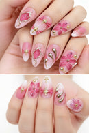 Nails with pink floral and decorative designs on a white background, Obroi