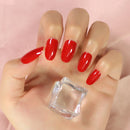 Hand with red nails and a clear nail polish bottle on a pink background, Obroi