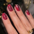 Hand with red glittery nail polish on a blurred background, Obroi