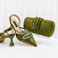 Green high-heeled shoes with embellishments and a matching clutch on a white background, Obroi