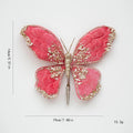 Decorative pink butterfly with gold embellishments on a white background, Obroi