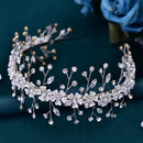 Silver floral tiara with crystals on a dark blue background