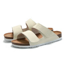 Pair of cream-colored sandals with brown soles on a white background, Obroi