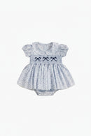 Baby dress with ruffled sleeves and embroidered bows on a white background, Obroi