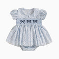 Baby dress with ruffled sleeves and embroidered bows on a white background, Obroi
