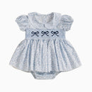 Baby dress with ruffled sleeves and embroidered bows on a white background, Obroi