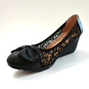 Black wedge shoe with lace detailing on a white background, Obroi