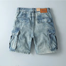 Blue denim cargo shorts with a brand label on a light gray background, Obroi