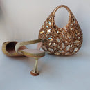 Gold embellished sandal and handbag on a white background, Obroi