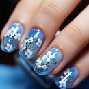 Nails with blue and white floral design on a blurred background, Obroi