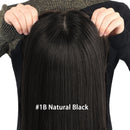 Person holding a large black hair extension labeled '