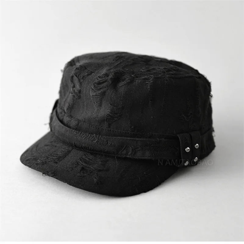 Black distressed cap with metal embellishments on a white background, Obroi