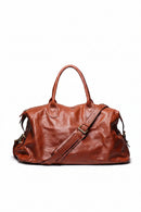 Brown leather bag with a shoulder strap on a white background, Obroi
