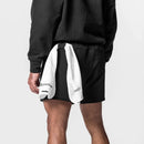 Person wearing a black outfit with a white towel draped over their shoulder on a light gray background, Obroi