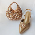 Gold handbag and shoe with embellishments on a light background, Obroi