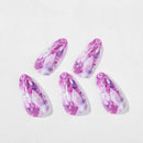 Five marquise-cut gemstones with a pink and purple marbled pattern, arranged on a clean white background, Obroi