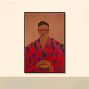 Framed artwork of a person wearing a colorful patterned garment on a beige wall, Obroi