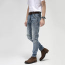 Person wearing light blue jeans with a white background, Obroi