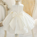 White dress with a large bow on a mannequin against an elegant background, Obroi