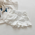 White denim shorts with ruffled edges on a light gray background, Obroi