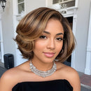 Woman with styled hair wearing a black top and silver necklace indoors, Obroi