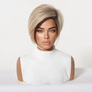 A short, layered wig with a warm blonde and light brown ombré color, styled on a mannequin bust wearing a white sleeveless top against a plain white background, Obroi