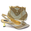 A gold rhinestone-embellished slingback high-heel shoe with a matching gold rhinestone clutch bag, displayed on a clean white background, Obroi