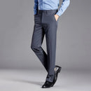 Person wearing gray dress pants with a blue shirt on a gray background, featuring the brand 'Obroi'.