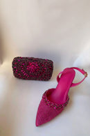 Pink high-heeled shoe with embellishments and matching clutch on a white background, Obroi