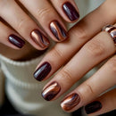 Close-up of hands with maroon and bronze nail polish, Obroi