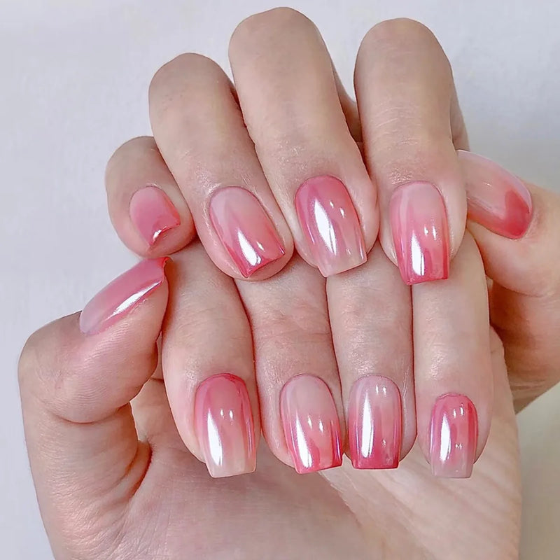 Hand with pink gradient nail polish on a white background, Obroi