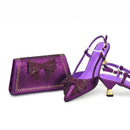 Purple high-heeled shoes and matching clutch with bow design on a white background, Obroi
