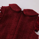 Close-up of a red textured garment with a collar on a light gray background, Obroi