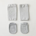 Set of gray baby booties with textured sole on a light gray background, Obroi