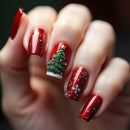 Close-up of a hand with red nail polish featuring Christmas tree and snowflake designs, Obroi
