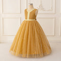 Yellow lace dress on a mannequin against a white paneled wall, Obroi