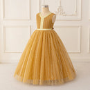Yellow lace dress on a mannequin against a white paneled wall, Obroi