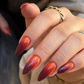 Close-up of a hand with maroon and orange gradient nails, Obroi