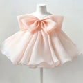 Pink dress with a large bow on a mannequin against a light gray background, Obroi