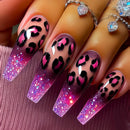 Nails with pink and black leopard print design on a textured surface, Obroi