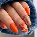 Obroi Close-up of a hand with orange nail polish and floral design, wearing denim.