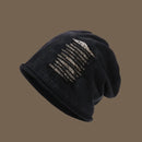 Black beanie with decorative pattern on a brown background, Obroi