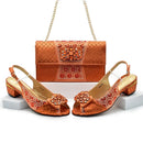 Orange shoes with floral details and matching bag on a white background, Obroi