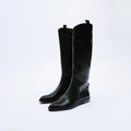 Pair of black knee-high boots on a white background, Obroi