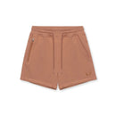 A pair of dusty rose drawstring shorts with a zippered pocket on the left side and a small embroidered logo on the lower right leg, shown against a plain white background, Obroi